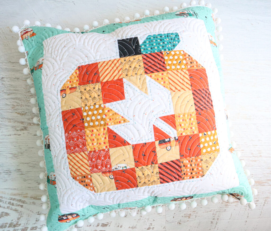 https://flamingotoes.com/wp-content/uploads/2023/08/Patchwork-Pumpkin-Pillow-1024x875.jpg